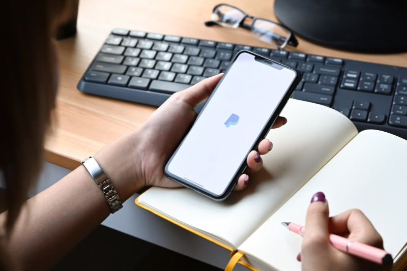 How to Withdraw Money from PayPal to M-PESA Woman using Paypal app on a smartphone