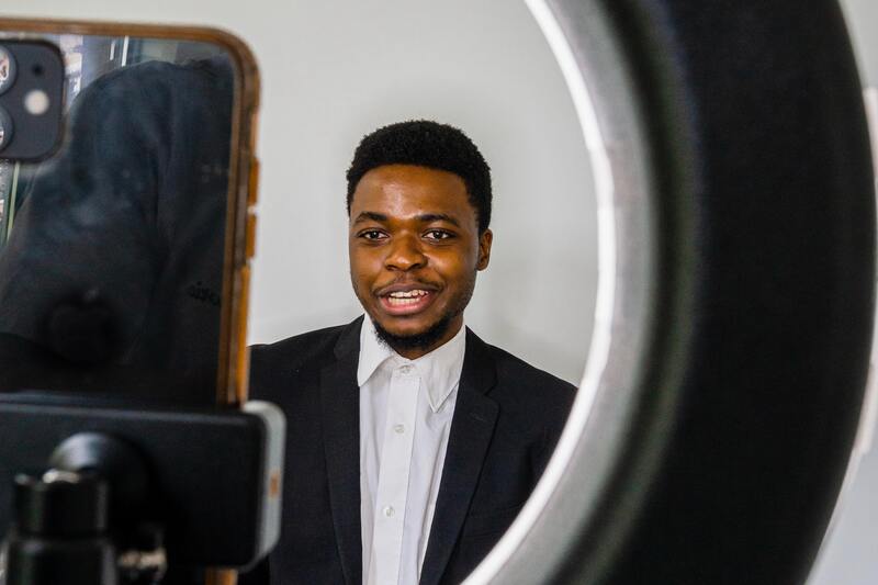 8 Challenges You’ll Face When Starting a YouTube Channel Man shooting a video on a phone and ring light