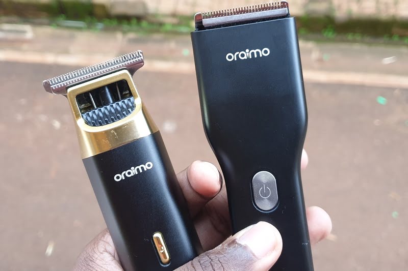 Man holding two Oraimo shaving machines