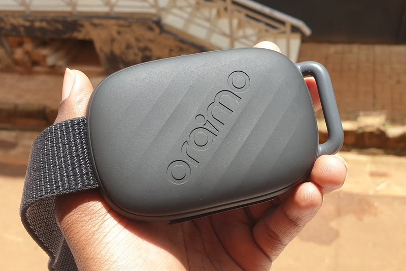 Man holding a portable Bluetooth speaker