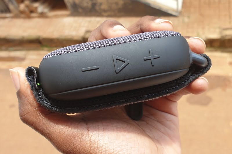 Man holding a portable Bluetooth speaker