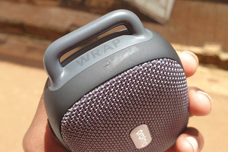 Man holding a portable Bluetooth speaker