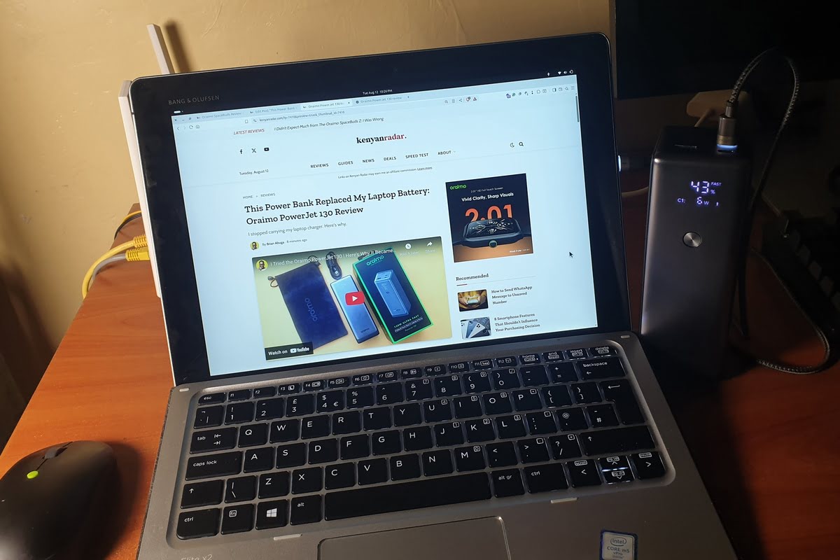 Laptop being charged by oraimo power bank