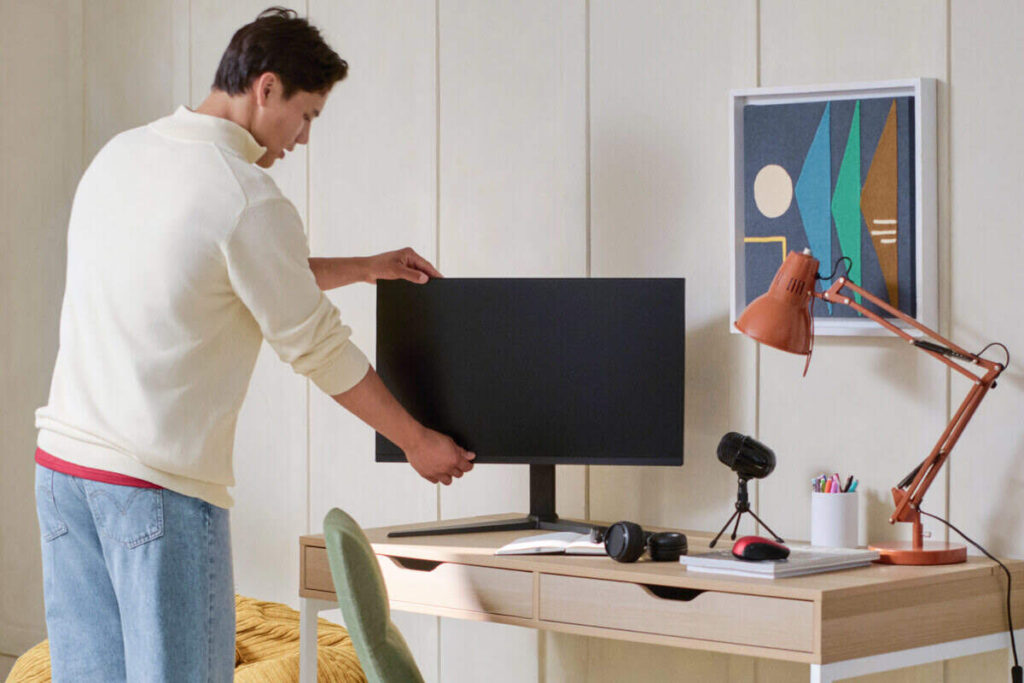 6 Amazon Basics Gadgets That Are Actually Good Man with a few amazon basic gadgets on a desk